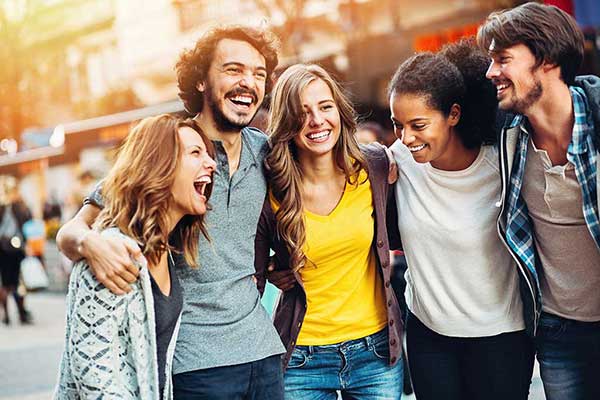 Group of friends with arms around each other walking