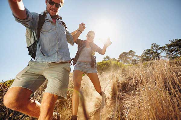 Man and woman running down a walking trail