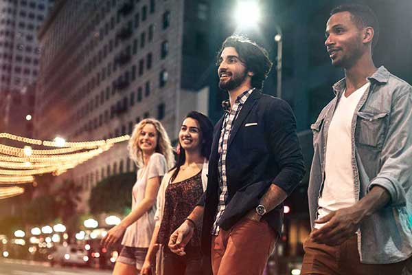 Group of friends walking in the street at night