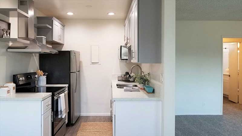 Kitchen and living room interior photo of Bleu Apartments