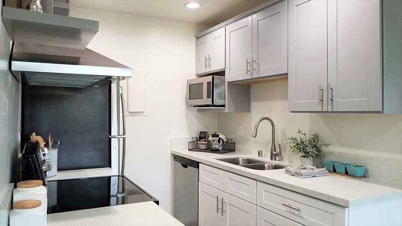 Kitchen sink and cupboards interior photo of Bleu Apartments